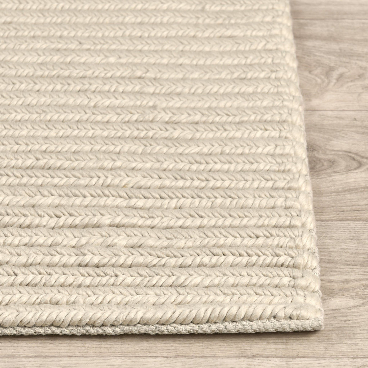 Dawson rug edge detail in light cream with tightly woven stripe texture and border