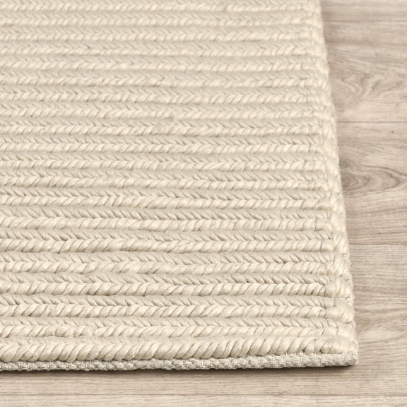 Dawson rug edge detail in light cream with tightly woven stripe texture and border