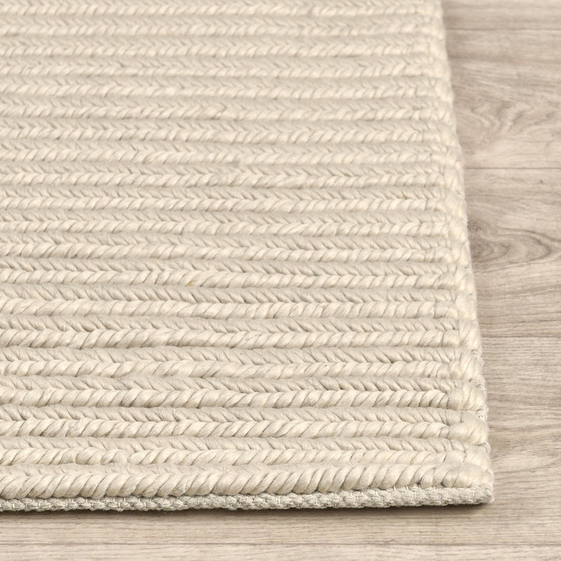Dawson rug edge detail in light cream with tightly woven stripe texture and border