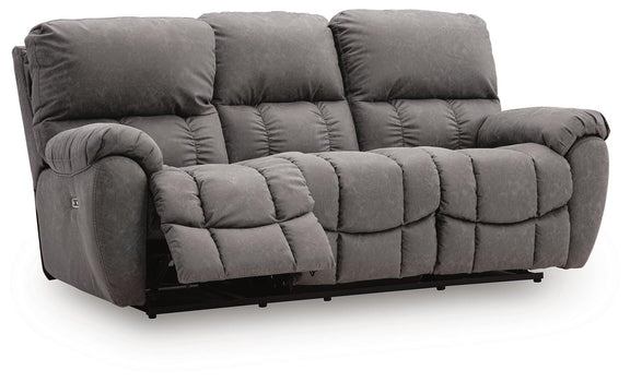 Dark gray power reclining sofa with adjustable headrest and cushioned armrests, tufted