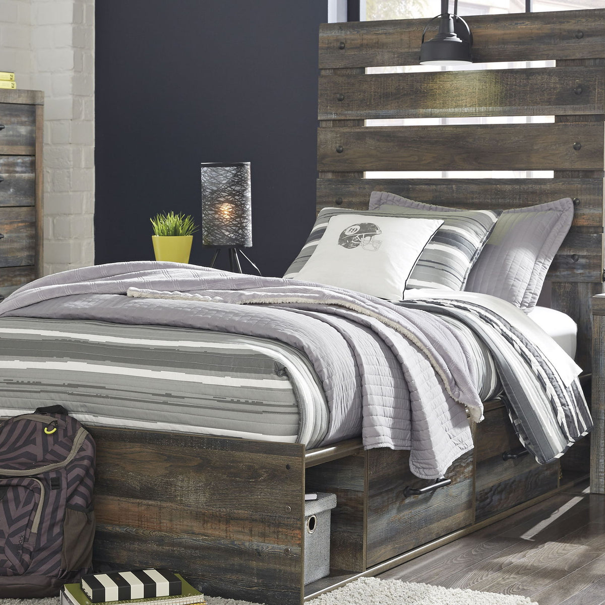 Drystan panel bed with dark wood panel headboard, side storage drawers, and striped bedding.