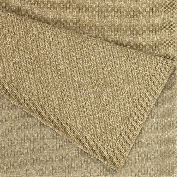 Beige jute area rug corner close-up, flat woven texture and stitched edge