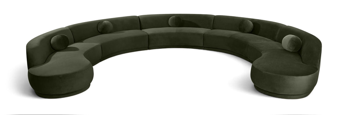 Forest green velvet sectional sofa with rounded, button-tufted seat cushions.