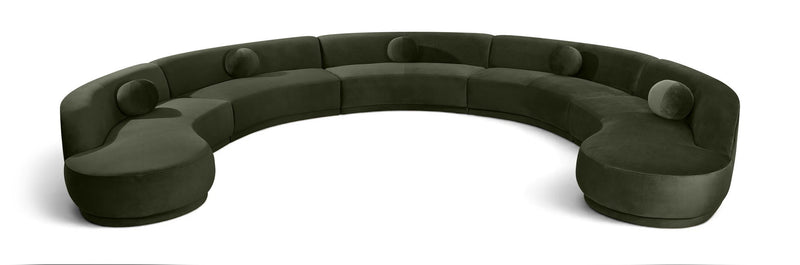 Forest green velvet sectional sofa with rounded, button-tufted seat cushions.