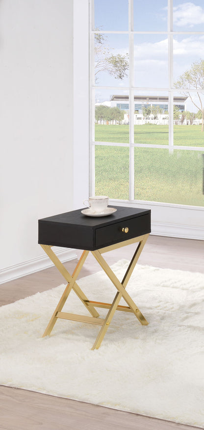 Black accent table with one drawer, gold-tone crossed legs, lower support shelf.