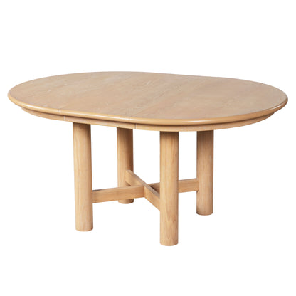 Light brown oval dining table with leaf, X-style support and tapered legs.