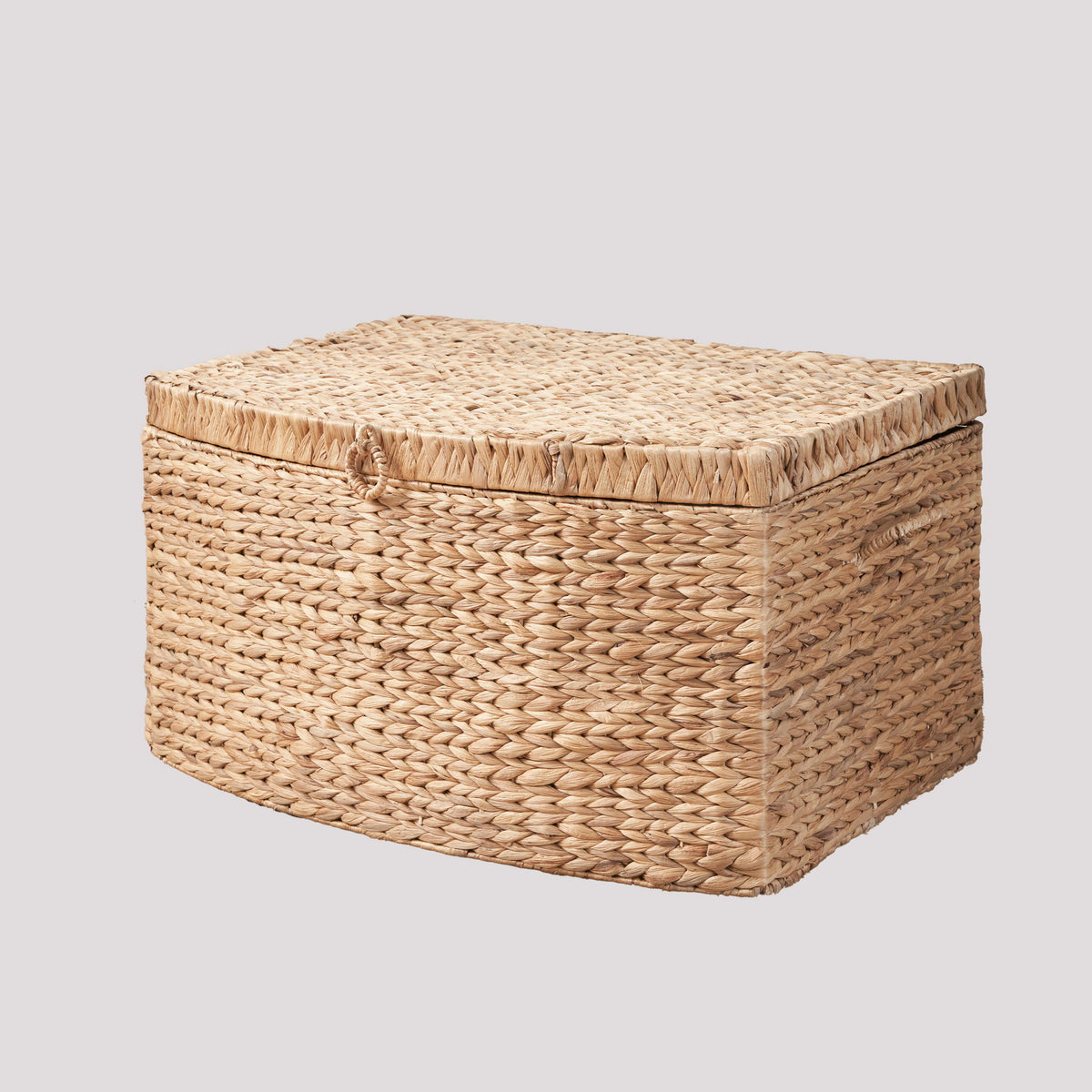 Light brown woven rectangular storage trunk with a fitted lid and loop handle