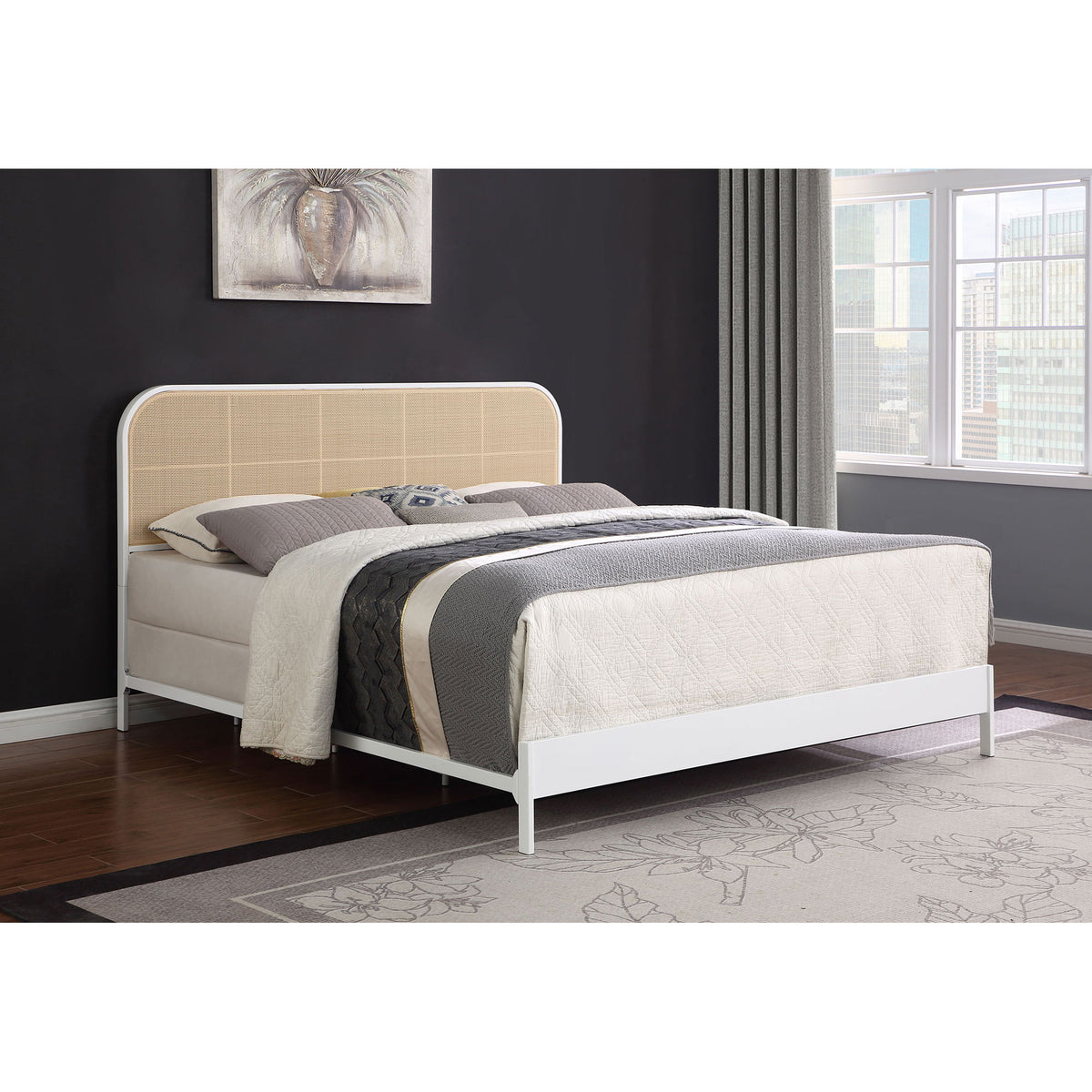 Black metal bed frame with tan woven headboard panel and slatted base.