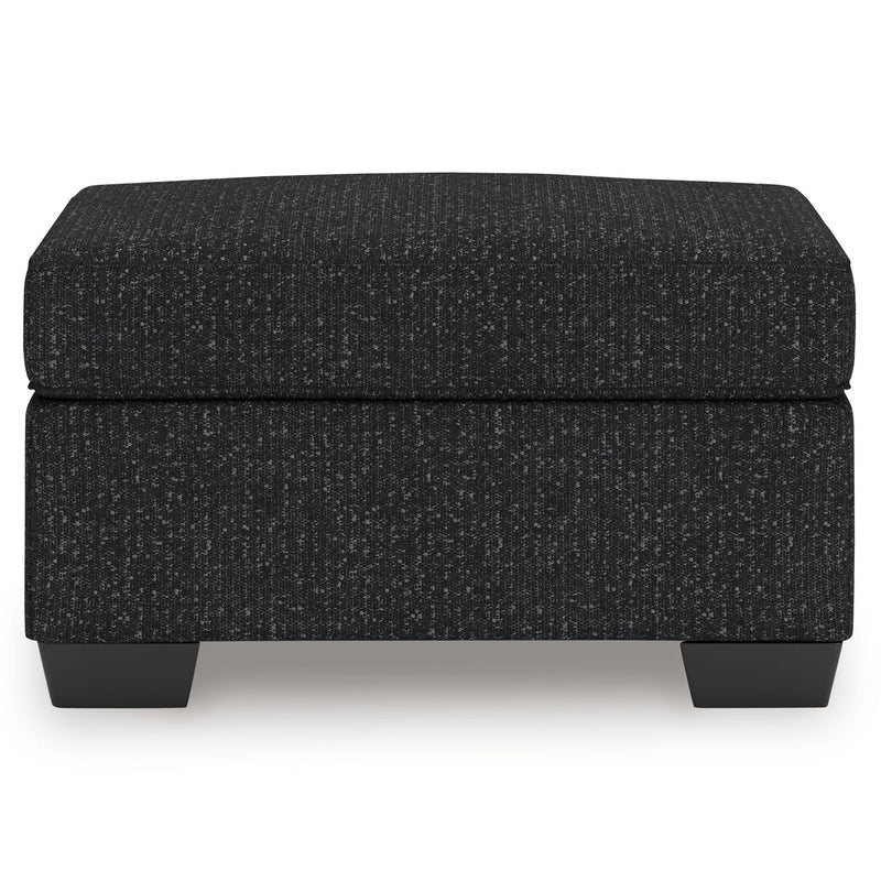 Charcoal upholstered ottoman with black legs and rectangular cushioned top