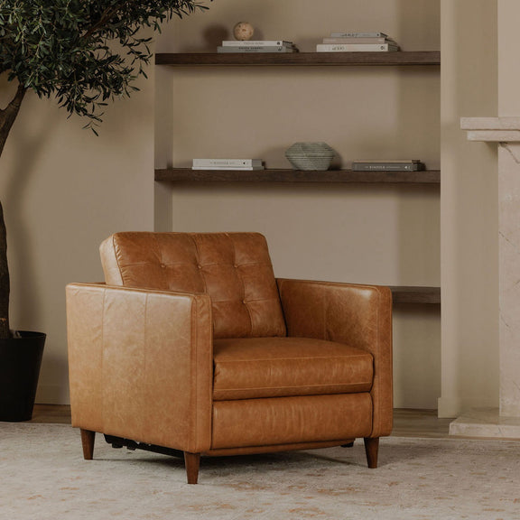 Tan leather power recliner chair in upright position, with button-tufted back and wood legs