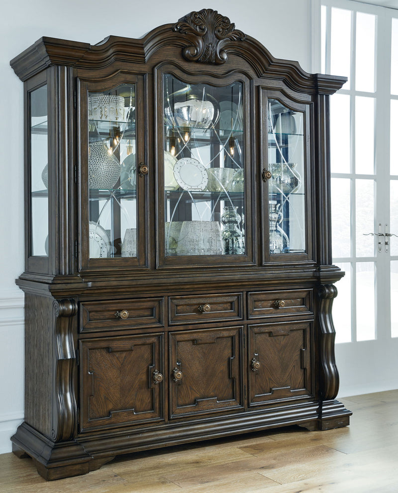 Dark brown dining buffet hutch with three glass doors and paneled cabinet base
