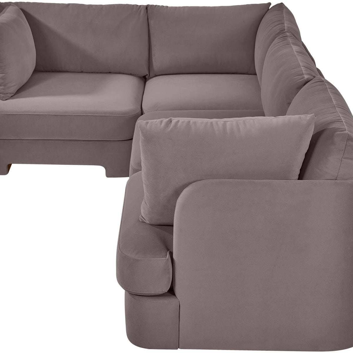 Light gray velvet sectional sofa with curved arms and square throw pillow cushions