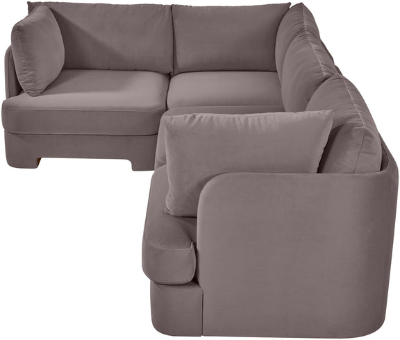 Light gray velvet sectional sofa with curved arms and square throw pillow cushions