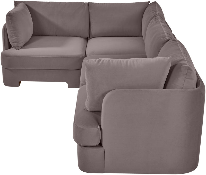 Light gray velvet sectional sofa with curved arms and square throw pillow cushions