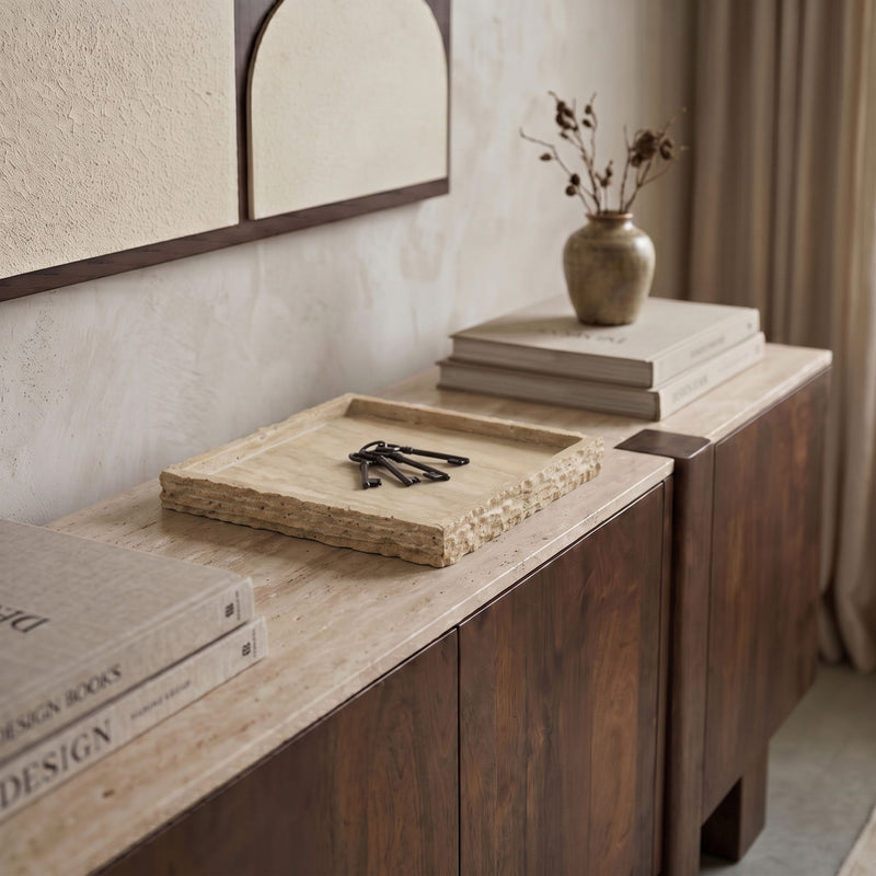 Beige travertine tray on tabletop, square with raised border and speckled texture.