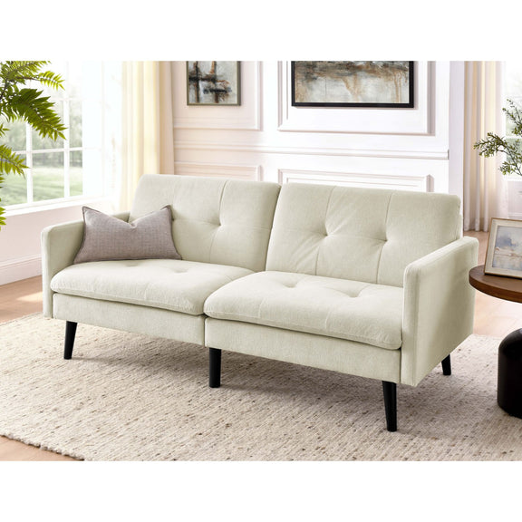 Light beige futon sofa with tufted back and seat cushions, shown in a living room