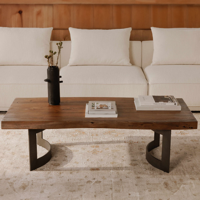 Smoked wood coffee table with dark metal legs and curved bracket supports