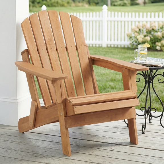 Light brown folding Adirondack chair with slatted back and armrests
