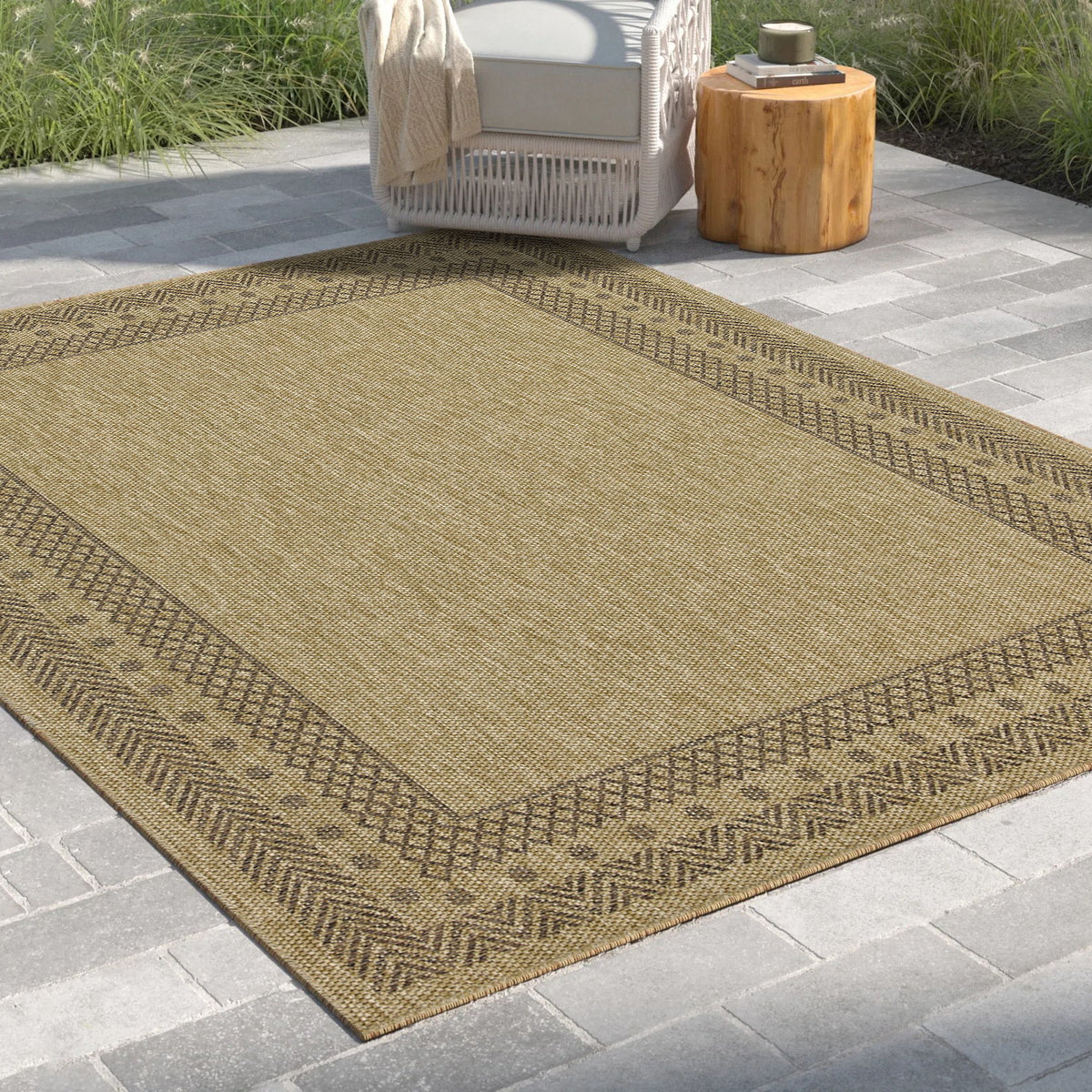 Light brown polypropylene area rug with zigzag border and flat-woven diamond pattern