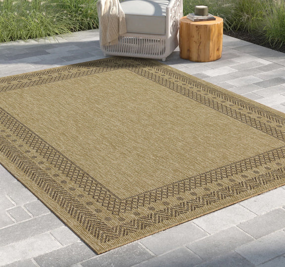 Light brown polypropylene area rug with zigzag border and flat-woven diamond pattern
