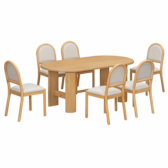 Light brown oval dining table with six upholstered chairs, rounded backs and fabric seats