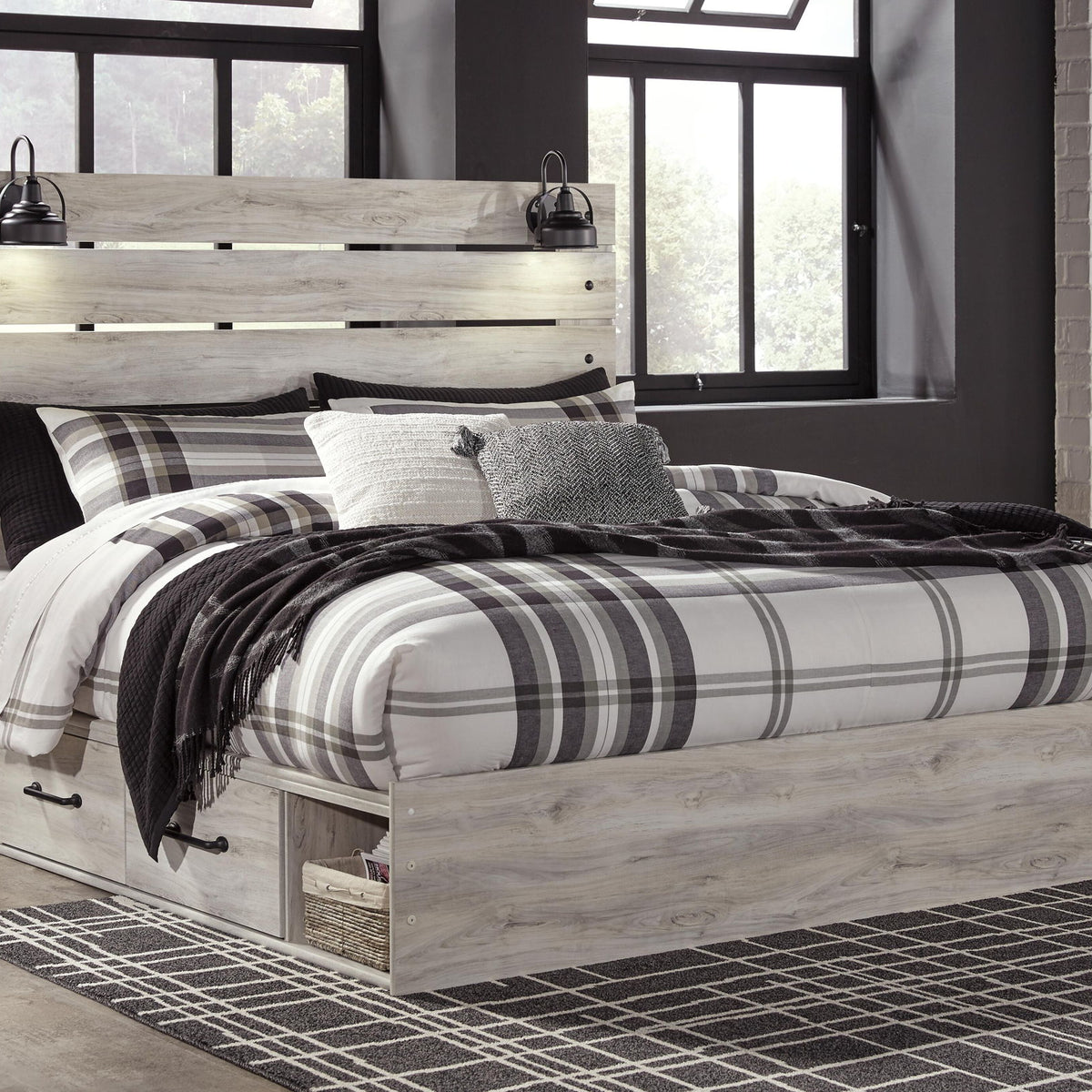 Cambeck panel bed with light wood frame, open footboard base, and matching bed linens