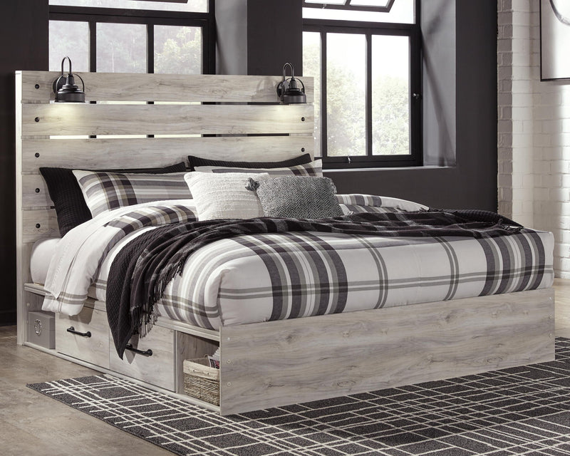 Cambeck panel bed with light wood frame, open footboard base, and matching bed linens