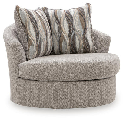 Swivel accent chair in textured gray fabric with striped throw pillows, rounded arms