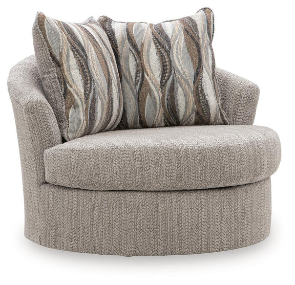 Swivel accent chair in textured gray fabric with striped throw pillows, rounded arms