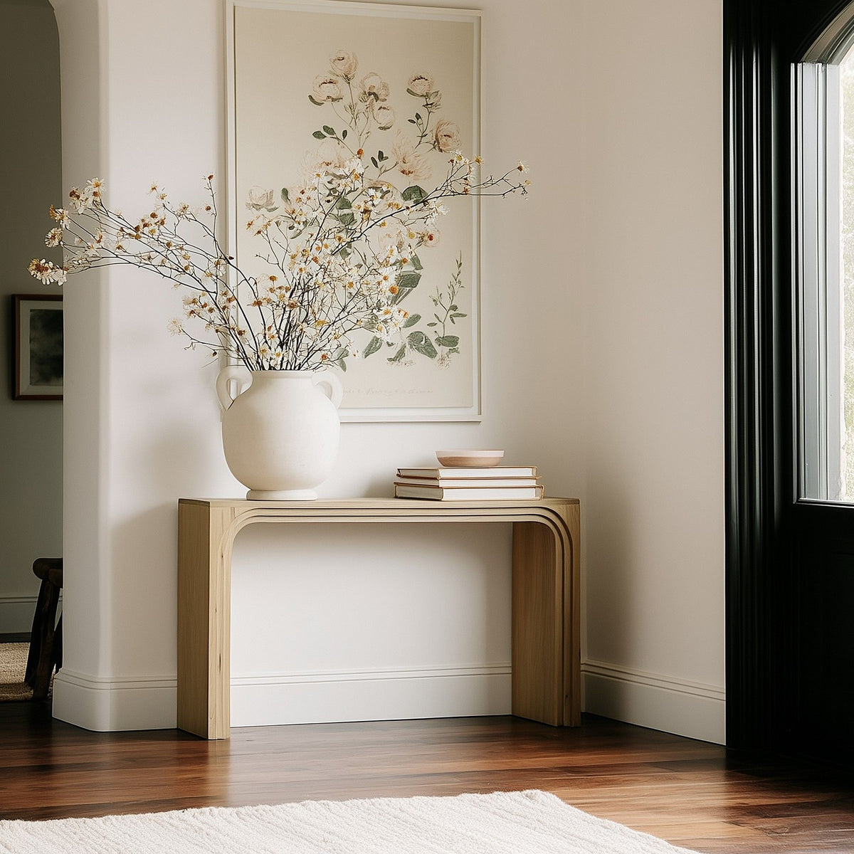 Natural console table with rounded legs and open apron design.