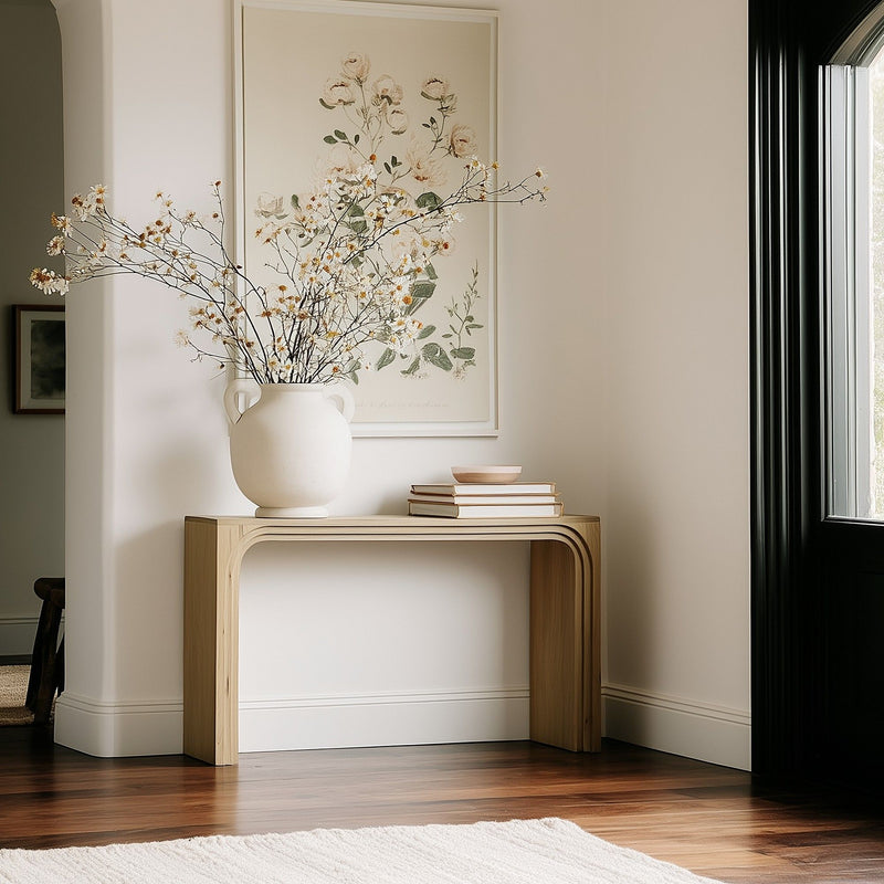 Natural console table with rounded legs and open apron design.
