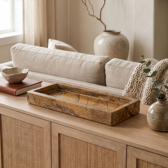 Marble tray on a wooden table with stones and keys for display