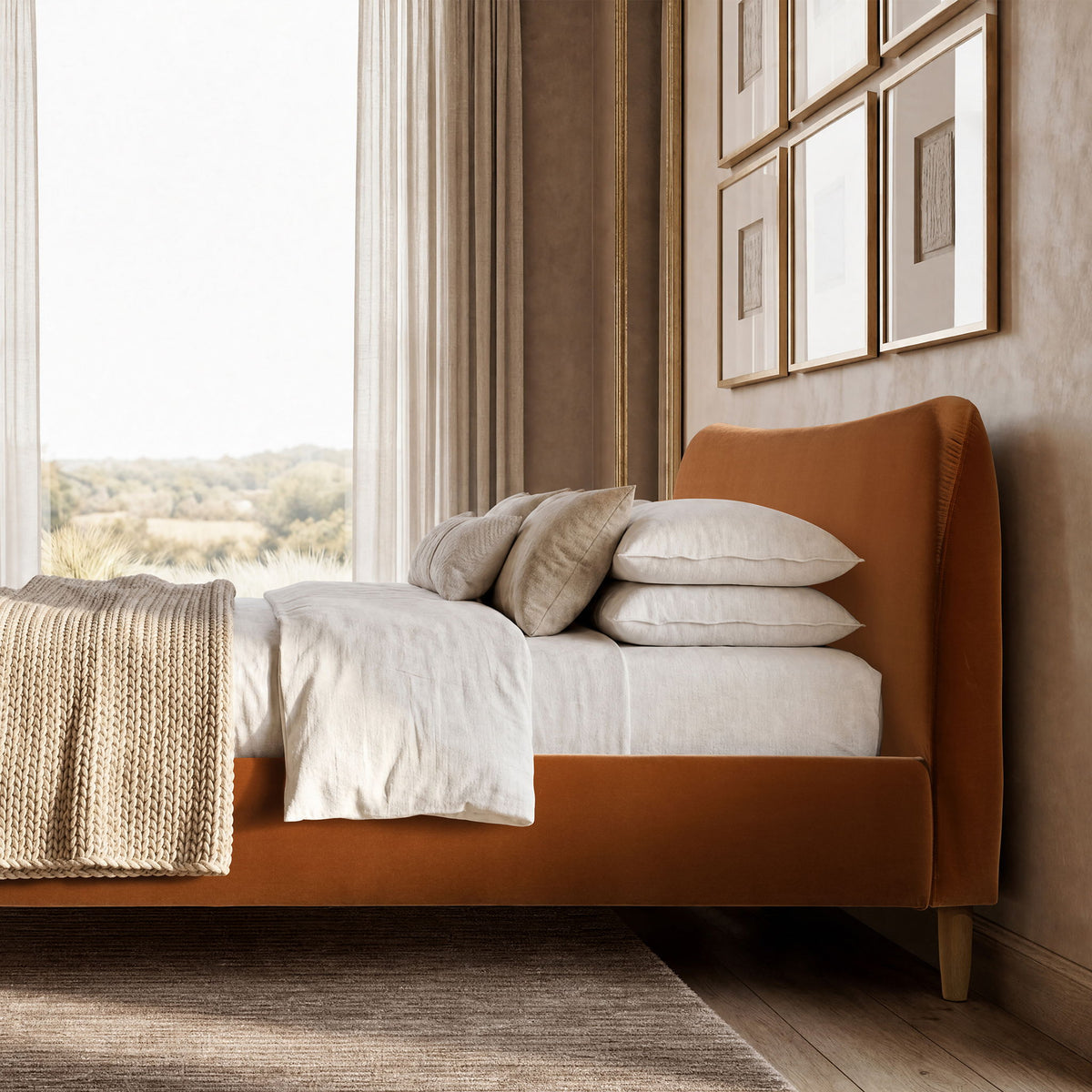Orange upholstered bed with curved headboard, platform base, styled with white linens