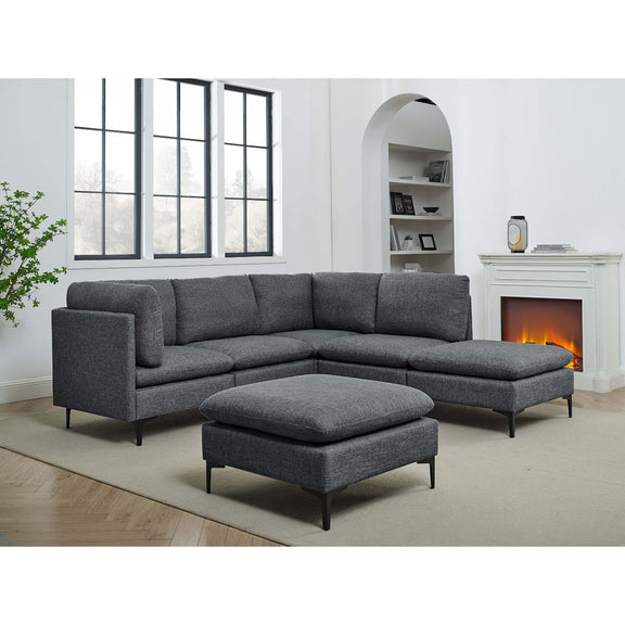 Modular sectional sofa with tall legs, upholstered in dark gray, with ottoman chaise