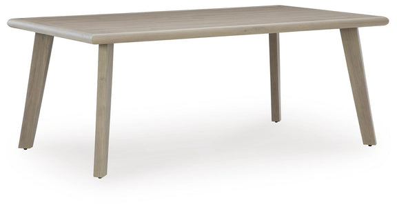 Beige rectangular patio dining table with rounded corners and four legs