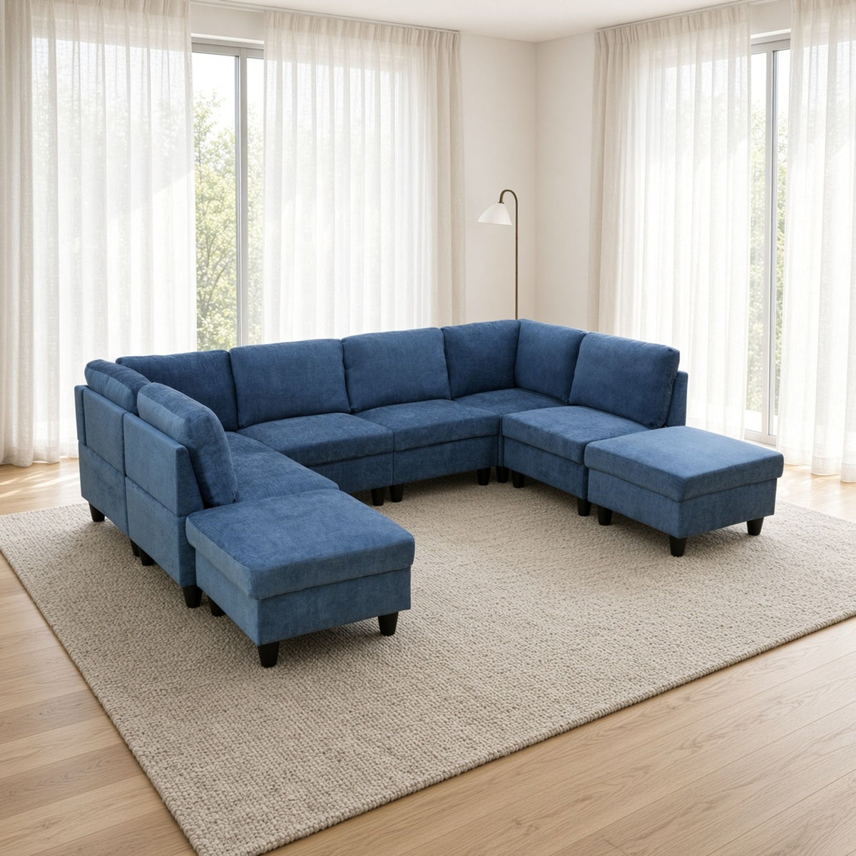 Blue U-shape modular sectional sofa with tufted cushions, chaise ottoman, and low arms
