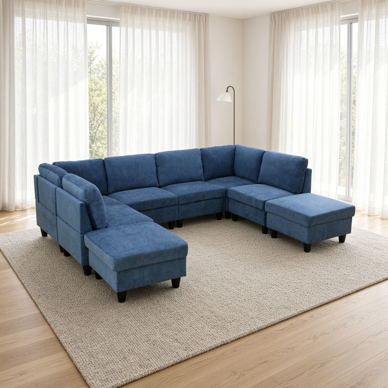 Blue U-shape modular sectional sofa with tufted cushions, chaise ottoman, and low arms