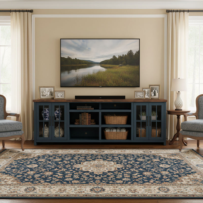 Blue TV stand console with center media shelf, drawers, and glass-door cabinets.