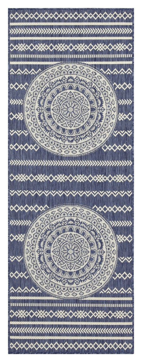 Indoor/outdoor area rug with dark navy background, light blue medallion motifs, and banded border