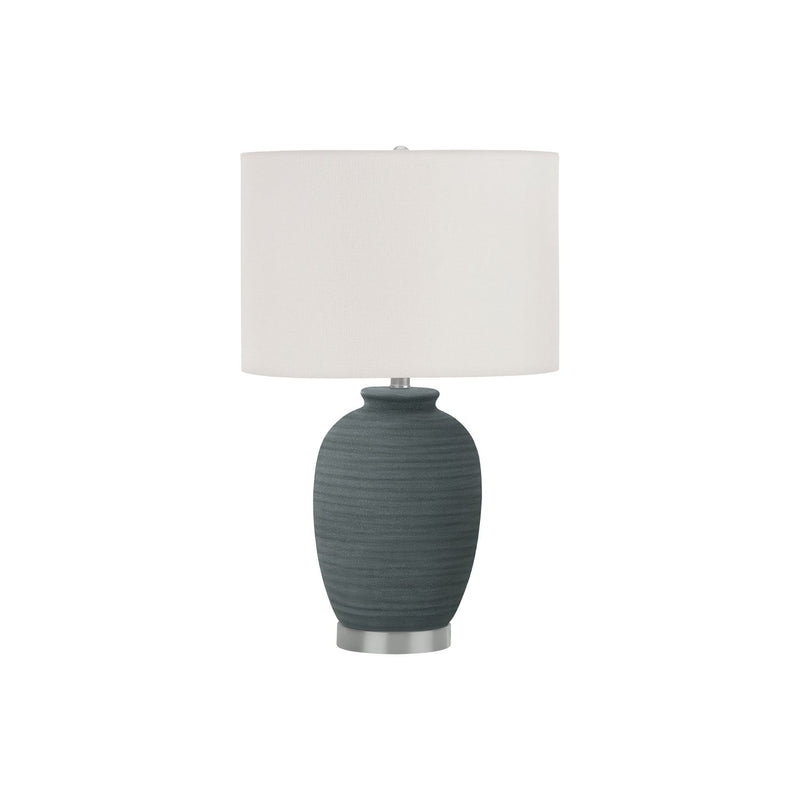 Dark blue ceramic table lamp with white fabric drum shade