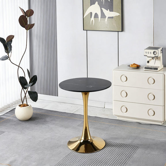 Round pedestal dining table with black top and gold pedestal base