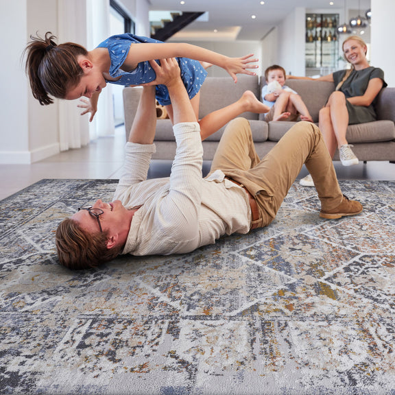 Traditional area rug with light gray, blue, and cream distressed design