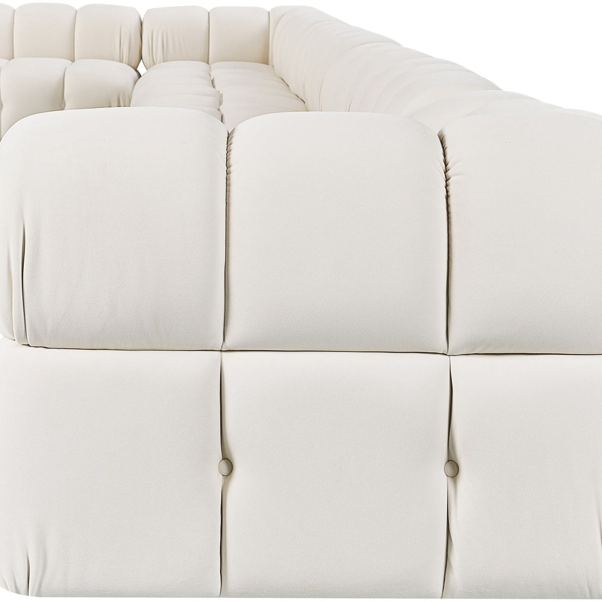 White velvet L-shaped sectional sofa with padded tufted seat and back cushions