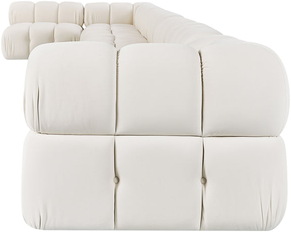 White velvet L-shaped sectional sofa with padded tufted seat and back cushions