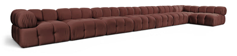L-shaped velvet sectional sofa in dark red with tufted cushions and rolled arms