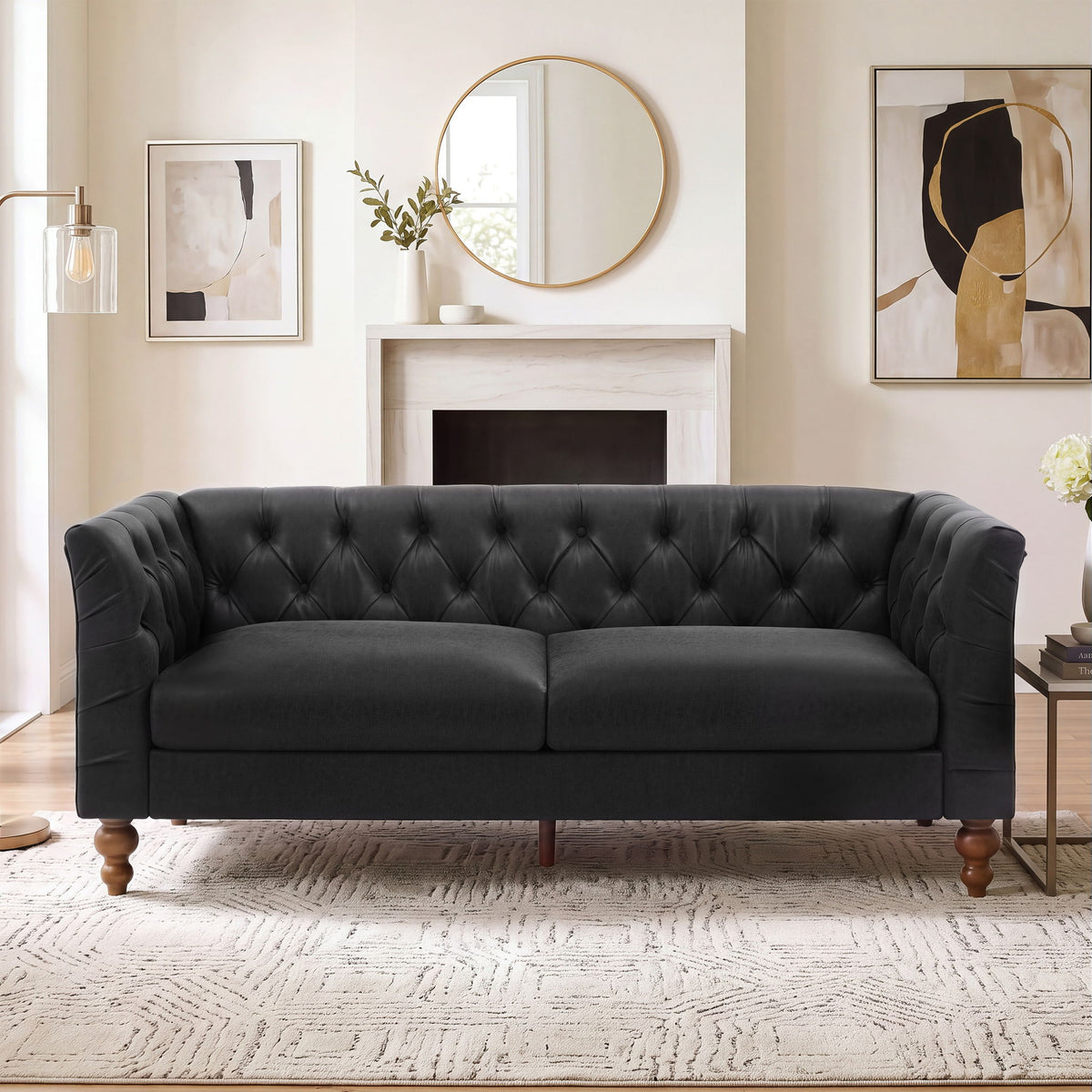 Black chesterfield-style sofa with tufted back, flared arms, and wooden legs
