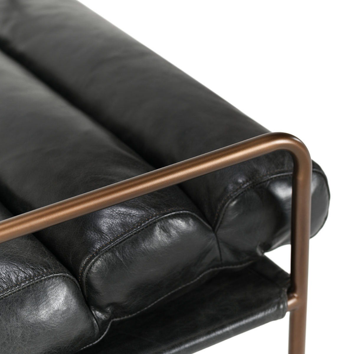 Jet black faux leather accent chair with bronze metal armrest and padded cushions