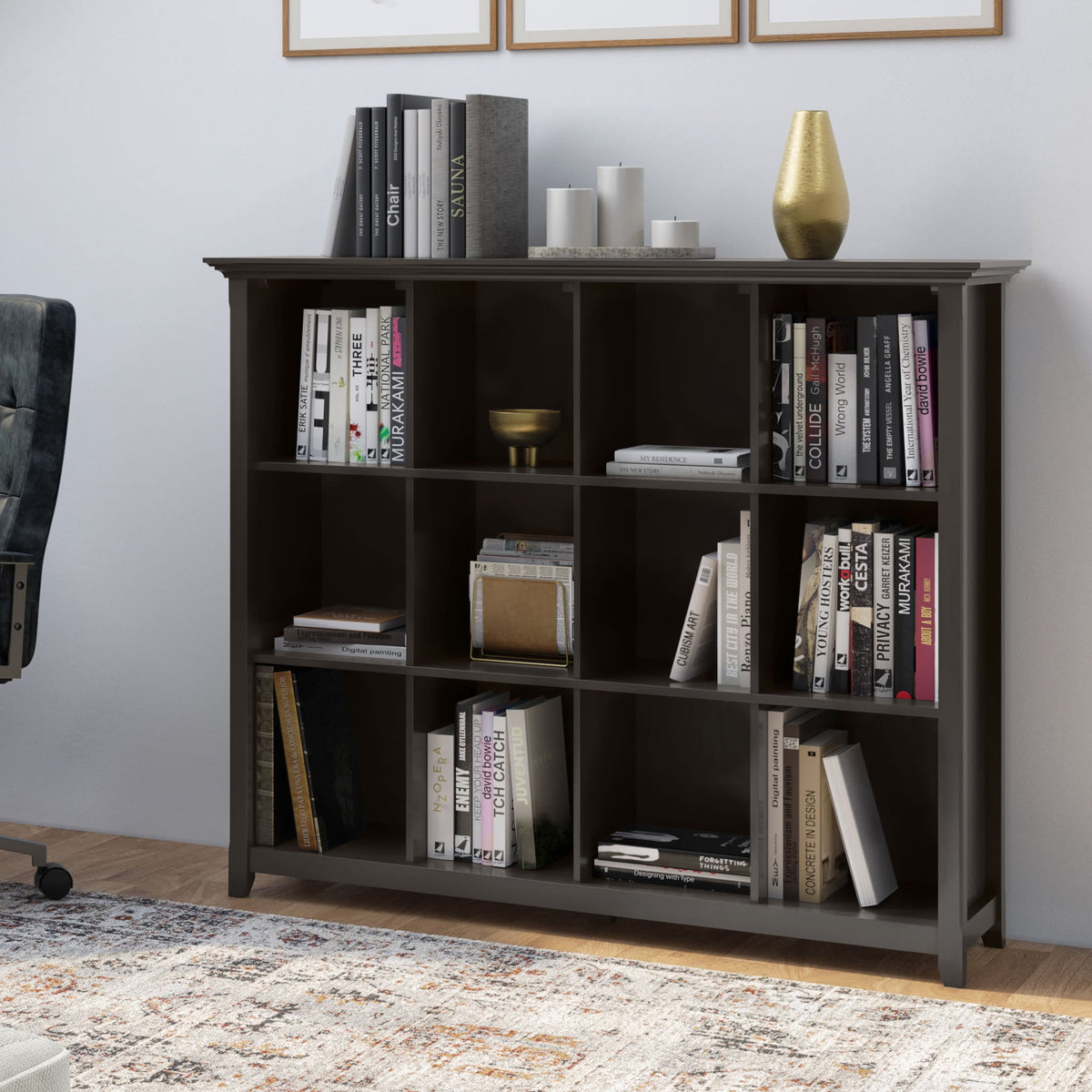 Dark gray cube storage bookcase with open cubbies holding books and decor