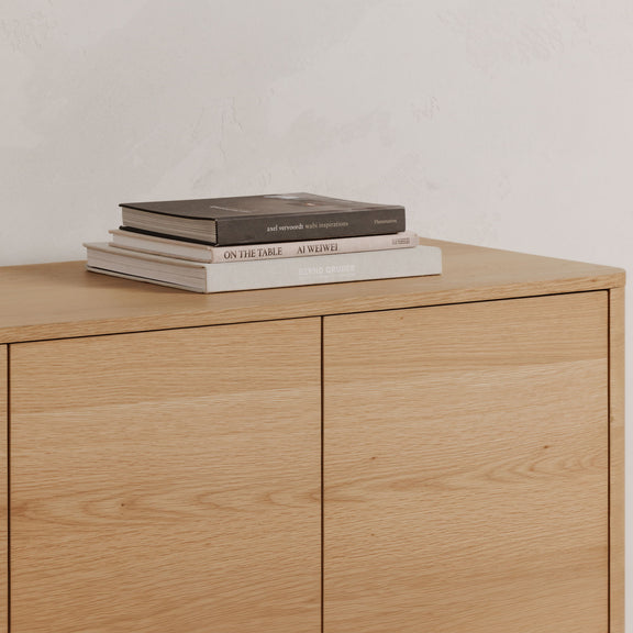 Light brown oak sideboard with two doors and smooth wood top surface