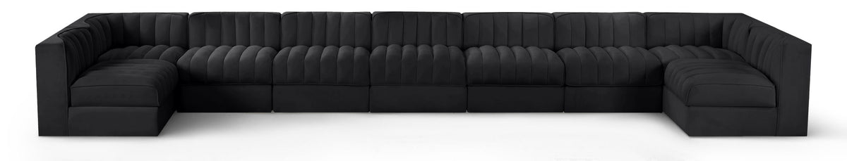 Black velvet modular sectional sofa with tufted cushions and curved armrests